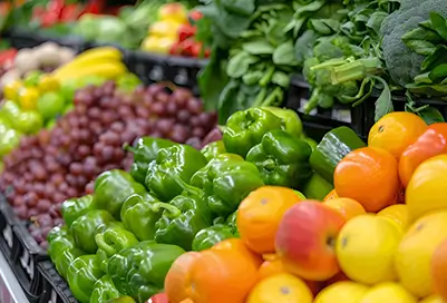 Produce in a grocery store. Fruits and vegetables of different colors lined up.